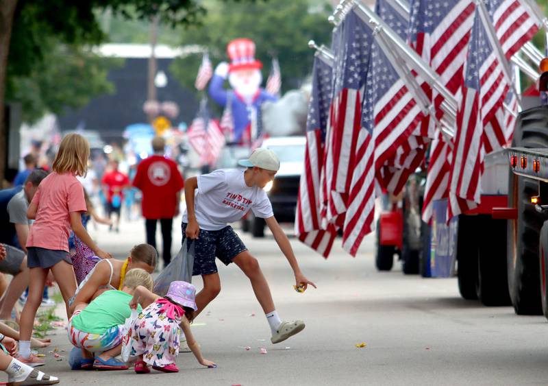 Kids gather candy as the Fiesta Days Parade makes its way down Main Street in McHenry on Sunday, July 20, 2025.