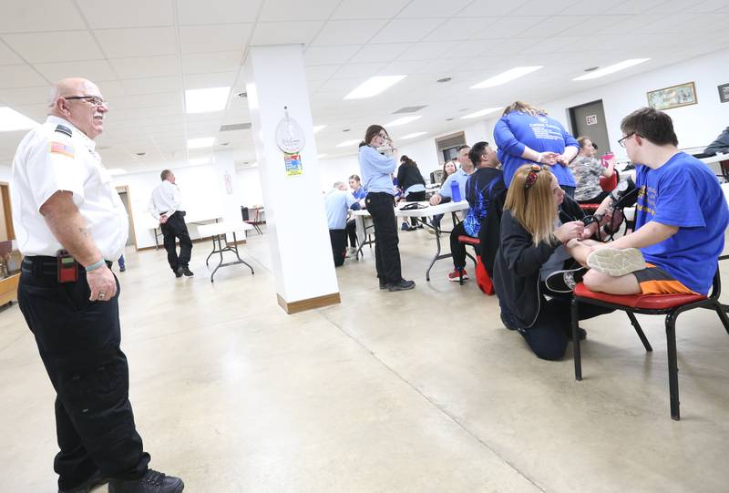 Andrew Jackson, Putnam County EMS Chief, (left) smiles while watching EMT Basic students interact with special needs students on Thursday, March 7, 2024 at the McNabb Fire Department. EMT Basic students trained with special needs students in Putnam County on how to work with the special needs kids so they will feel more comfortable and understand what will happen in an emergency. The training gave the EMT Basic students hands-on training on working with the special need students.