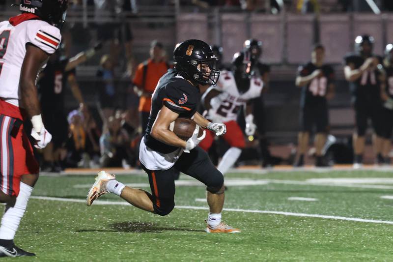 Lincoln-Way West’s Tyler Mansker returns an interception against Bolingbrook. Sept. 9, 2022, in New Lenox.