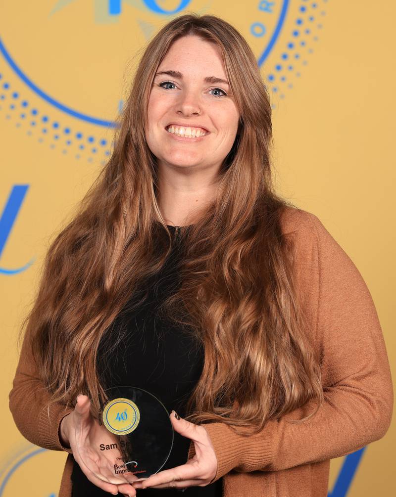Sam Setchell poses with her 40 Under Forty award during the Illinois Valley Chamber of Commerce Champions of Change Awards Night on Thursday, April 10, 2025 at the Westclox Event Center in Peru.