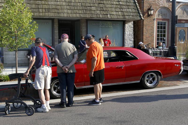 People check out 1969 Chevy Chevelle SS on Wednesday July 10, 2024, during the Cary Cruise Night. The weekly car show hosted by the Cary-Grove Area Chamber of Commerce draws about 125 cars and trucks each week. The event runs weekly on Wednesday through the end of August.