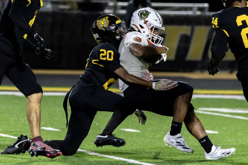 Joliet West's Marcus Jones tackles Plainfield East's David Croom during a varsity football game against at Joliet West on Oct. 10, 2025.
