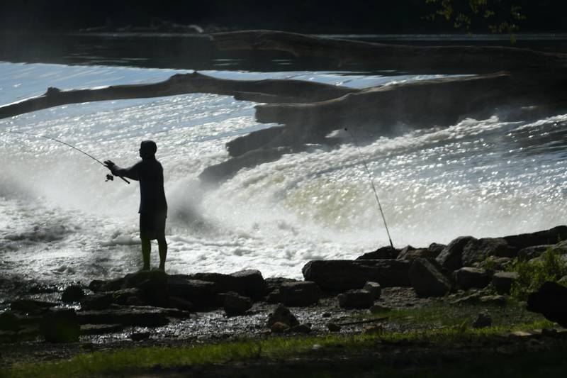 A lone fisherman tries his luck below the Oregon dam.