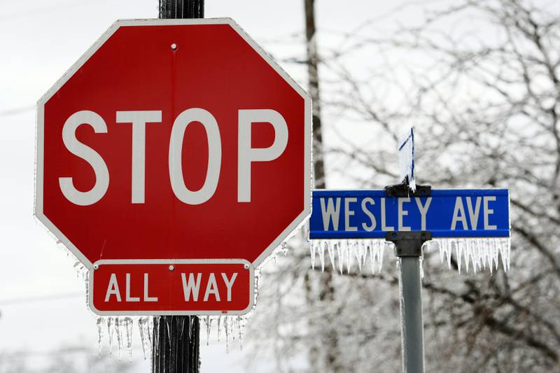 A coating of ice remained on street signs in Mt. Morris on Thursday following freezing rain that fell across portions of Ogle County on Wednesday. The ice storm, coupled with strong winds, caused electrical outages across the area.