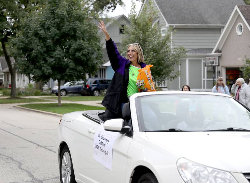 Downers Grove North Principal Courtney DeMent throws candy during the school’s homecoming parade on Friday, Sept. 23, 2022.