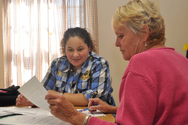 A Dominican Literacy Center volunteer, right, tutors a student in English.