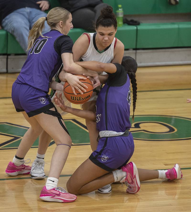 Rock Falls’ Autumn Weatherby fights for the ball against Dixon’s Addy Lohse (left) and Ahmyrie McGowan Wednesday, Jan. 31, 2024 at Rock Falls High School.