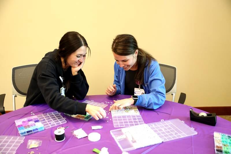 Registered nurses Kelsey Hawa (left) and Alex Stankus (right) make friendship bracelets as part of Northwestern Medicine Central DuPage Hospital’s National Nurses Week activities on Monday, May 6, 2024.