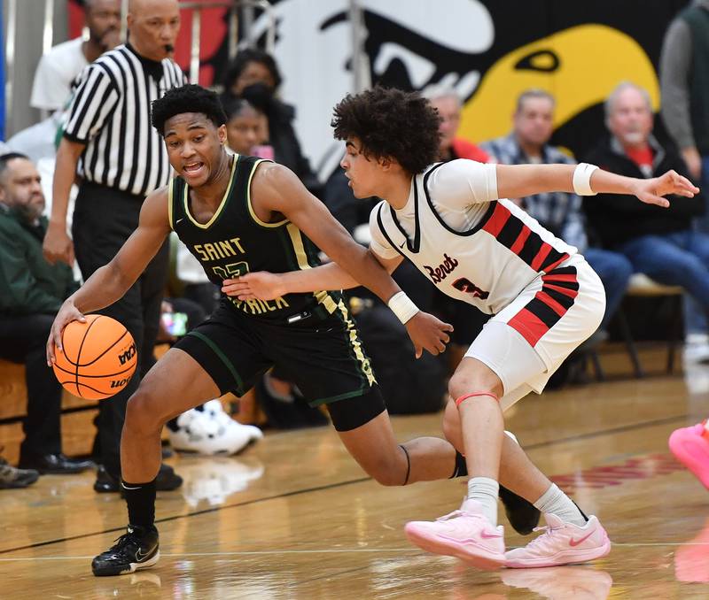 Benet’s Jayden Wright (3) plays tight defense on St. Patrick’s EJ Breland during a game on January 17, 2025 at Benet Academy in Lisle.