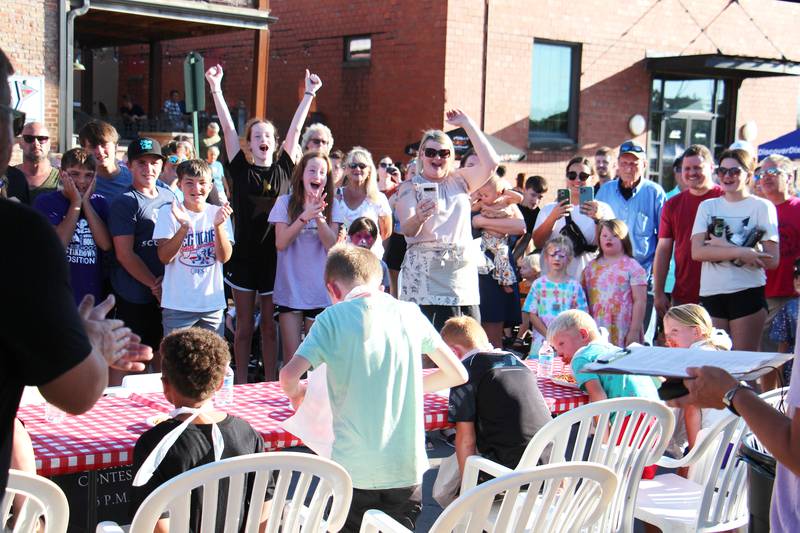 A crowd cheers for the contestants of the spaghetti eating contest Saturday, August 12, 2023 during Dixon’s Venetian Night. Along with the “gastrological” display visitors to the riverside festival were greeted with street performers, mask makers, music and fireworks.