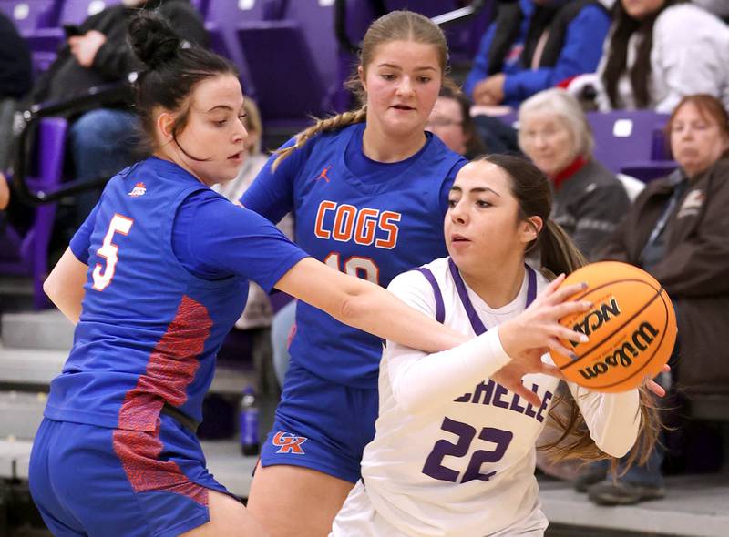 Rochelle's Gianna Olguin is trapped by Genoa-Kingston's Zoe Boylen (left) and Arielle Rich during their game Monday, Dec. 15, 2025, at Rochelle High School.