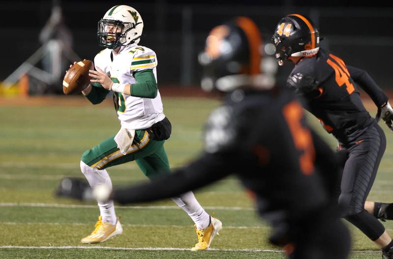 Waubonsie Valley's Luke Elsea looks for a receiver in the DeKalb secondary during their game Thursday, Oct. 20, 2022, at DeKalb High School.