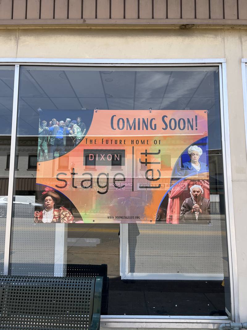 An orange "coming soon" sign posted on a glass window to celebrate Dixon Stage Left's new location at 105 S Peoria Ave.