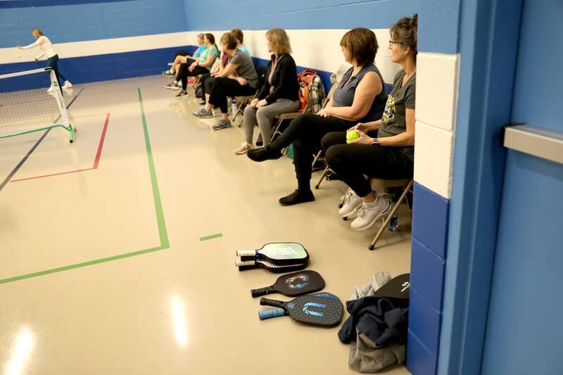 Players wait for their turn on the court during a pickle ball open gym session at the Pottawatomie Community Center in St. Charles on Jan. 23, 2023.