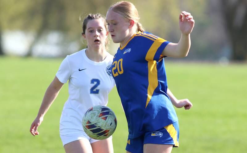 Johnsburg’s Kayla Hiller, right, battles Woodstock’s Sofia Krueger in varsity soccer on Wednesday, April 23, 2025, at Johnsburg High School in Johnsburg.