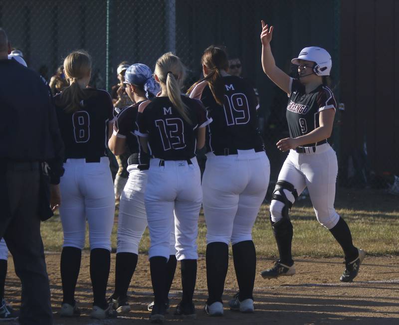 Marengo's Gianna Iovinelli is greeted by here teammates after hitting a home run during a nonconference softball game against Jacobs on Monday, March 9, 2026, at Marengo High School.