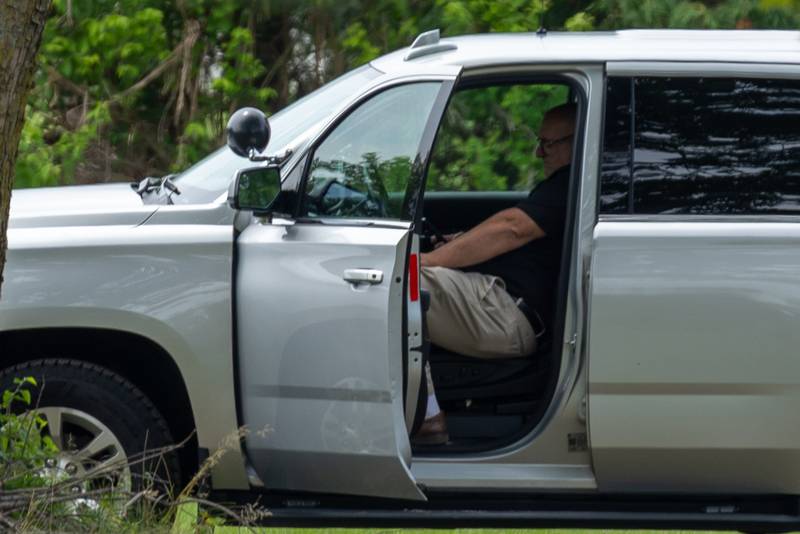 Man sits in law enforcement vehicle at crime scene of double homicide on Thursday, July 17, 2025 on 42nd Road in Sheridan.