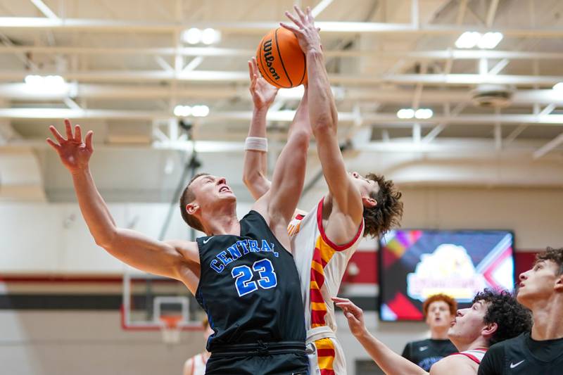 Burlington Central's Jacob Johnson (23) and Batavia's Jax Abalos (3) fight for a rebound during a Batavia Night of Hoops Basketball game at Batavia High School on Saturday, Jan. 25, 2025.