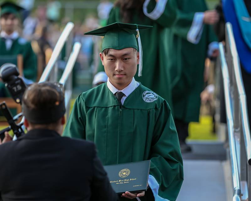 Students pose for pictures during the Glenbard West High School graduation ceremony. May 19, 2022