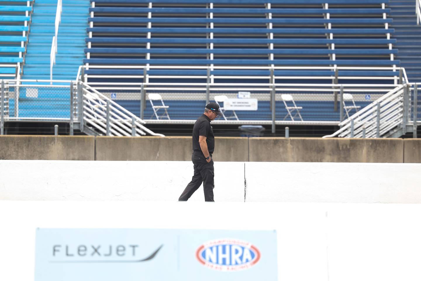A crew member walks the race track for the NHRA Route 66 Nationals this weekend at Route 66 Raceway on Thursday, May 16, 2024 in Joliet.