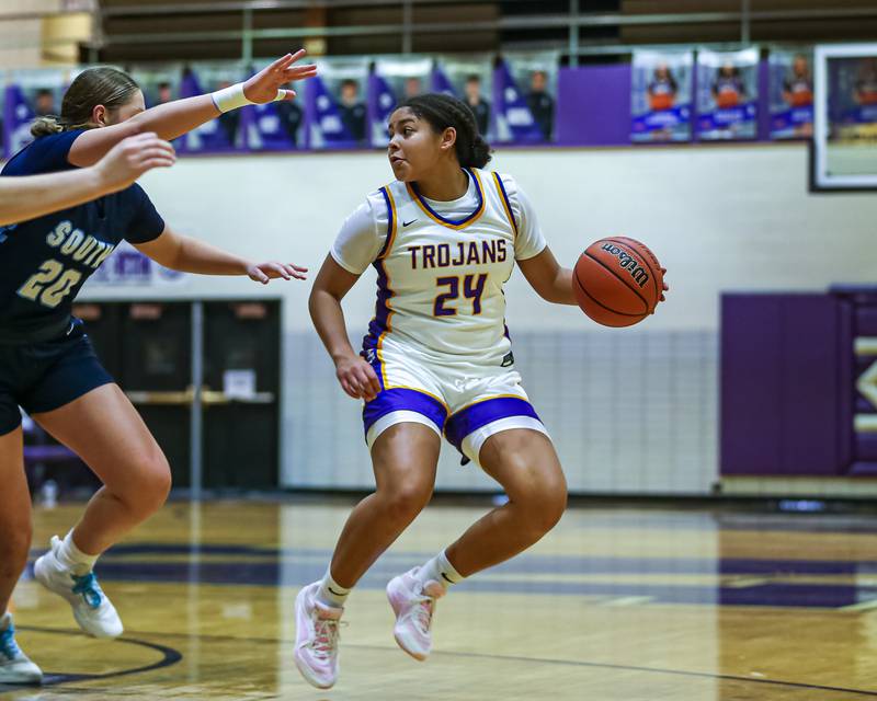 Downers Grove North's Kaitlyn Parker (24) makes a move on the defense during girls basketball game between Downers Grove South at Downers Grove North. Dec 16, 2023.