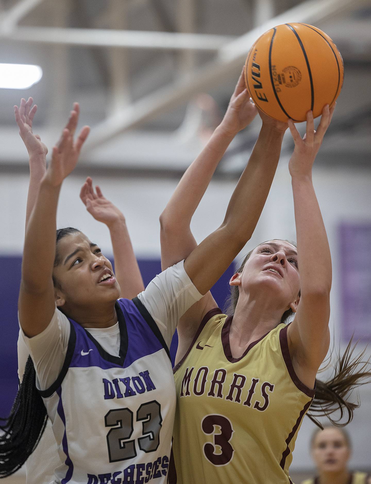 Dixon's Ahmyrie McGowan and Morris’ Lily Hansen battle for a ball Friday, Jan. 3, 2025, at Dixon High School.