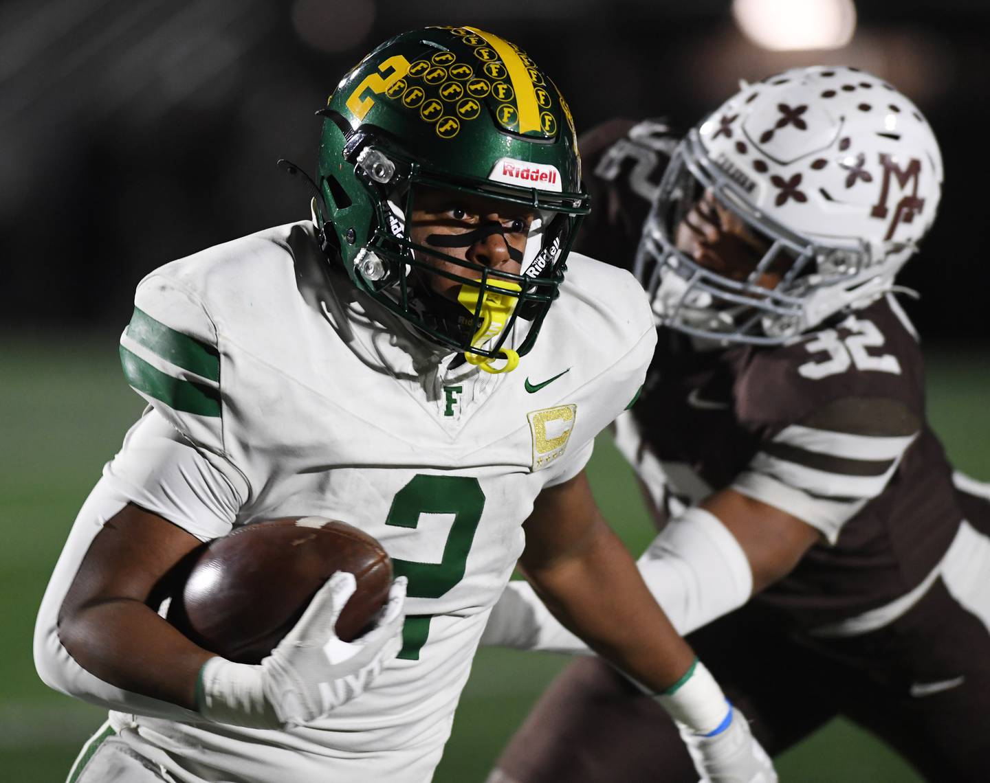 Fremd's Jayden Faulkner looks to get past Mount Carmel's Roman Igwebuike during the IHSA Class 8A football semifinal game on Saturday, Nov. 22, 2025 in Chicago.