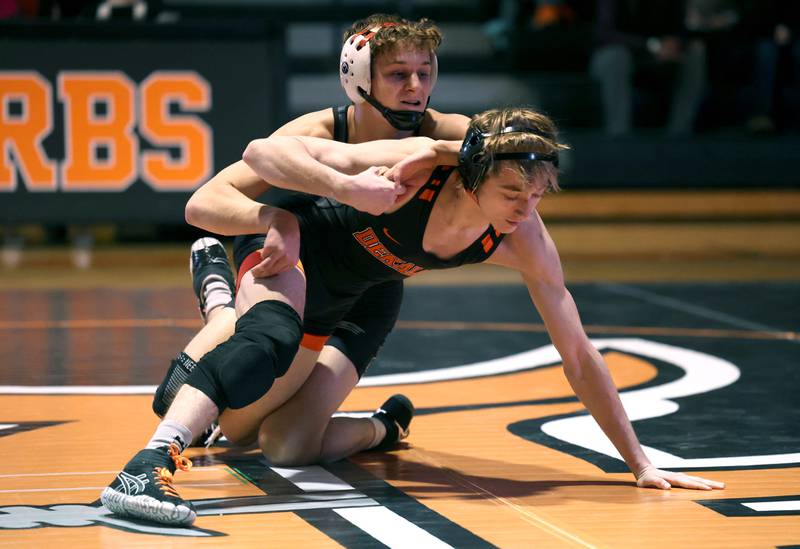 Sycamore’s Tyler Lockhart (top) tries to keep the advantage over DeKalb’s Tyler Daub Friday, Jan. 17, 2025, during their 126 pound match at DeKalb High School.