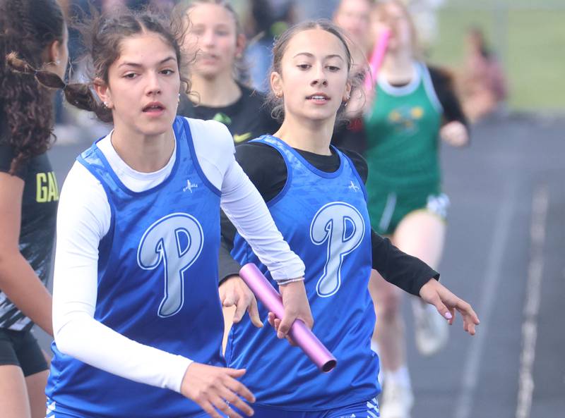 Princeton's Lelia Acker gets the baton from Ruby Acker in the 4x800 relay during the Class 2A Sectional track meet on Wednesday, May 13, 2026 in the Jeff Prusator Athletic Complex at Mendota High School.
