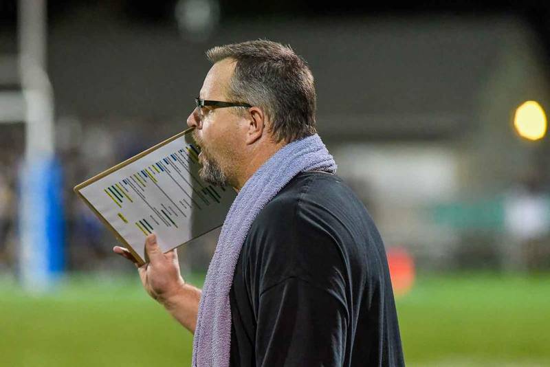 Woodstock North head coach Jeff Schroeder signals a play to his team during Friday's game at Woodstock. North won, 29-24.