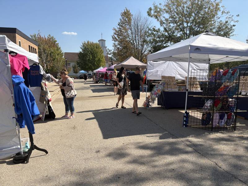 Shoppers look at merchandise at the Huntley Farmers Market Oct. 4, 2025.