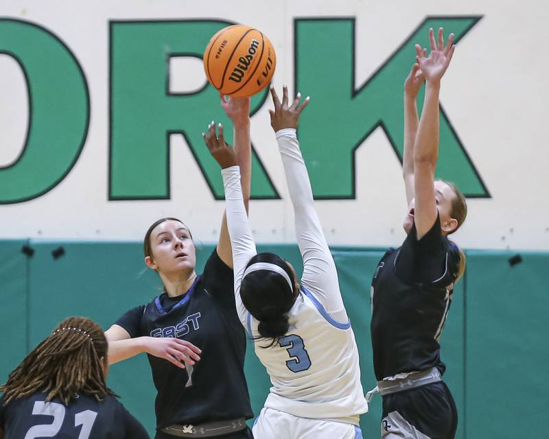 Oswego East's Aubrey Lamberti (1) blocks a shot by Downers Grove South's Jakylah Thomas (3) during their York Thanksgiving Tournament matchup between Oswego East at Downers Grove South Friday, Nov 20, 2025 in Elmhurst.