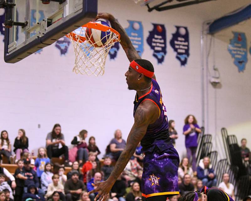 Harlem Wizard player Dragon dunks the ball during the game against the Downers Grove Staff on Sunday Jan. 19, 2025, held at Downers Grove South High School.