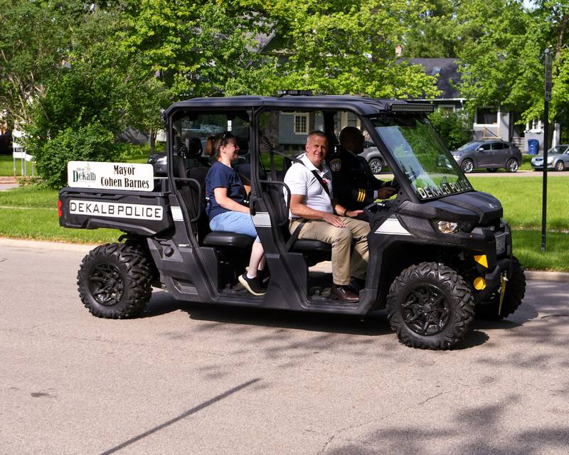 DeKalb Mayor Cohen Barnes smiles as he rides in the Memorial Day parade in downtown DeKalb on Monday, May 30, 2022.