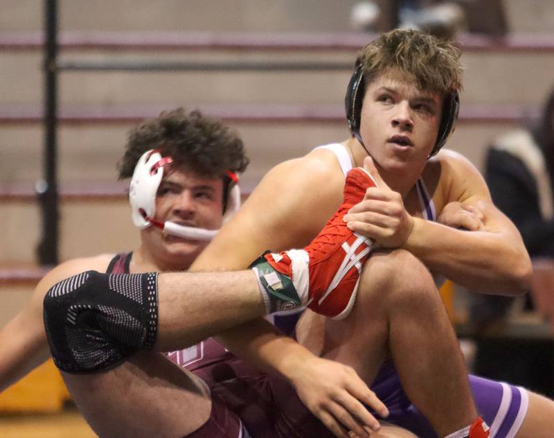 Prairie Ridge’s Frank Matviychuk, left, battles Hampshire’s Knox Homola at 215 pounds in varsity boys wrestling on Thursday, Dec. 4, 2025, at  Prairie Ridge High School in Crystal Lake.