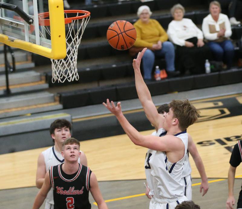 Marquette's Peter McGrath takes a shot in the lane against Woodland's John Moore during the Tri-County Conference Tournament on Thursday, Jan. 25, 2024 at Putnam County High School.