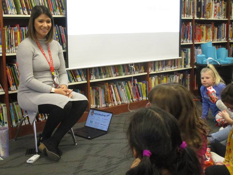 Yorkville Grade School social worker Adriana Resendiz greets students before the start of a yoga and mindfulness lesson.