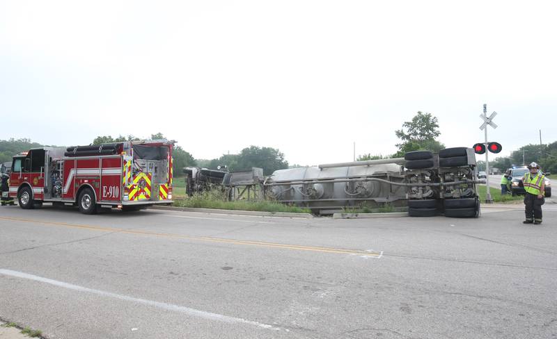 Wallace firefighters work the scene of an overturned sand hauler at the intersection of North 15th Road and U.S. Route 6 on Wednesday, July 9, 2025 in Ottawa. The semi overturned on the train tracks. La Salle County Sheriff and Ottawa Police assisted with the crash.