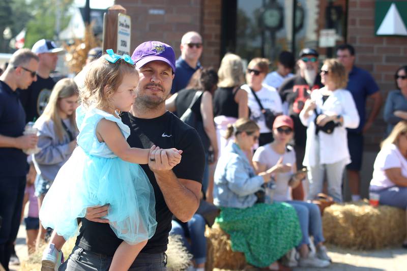 Shelby Temple of Lake in the Hills slow dances with his daughter Taylin, 2, to live music during the Johnny Appleseed Festival in Crystal Lake Saturday.