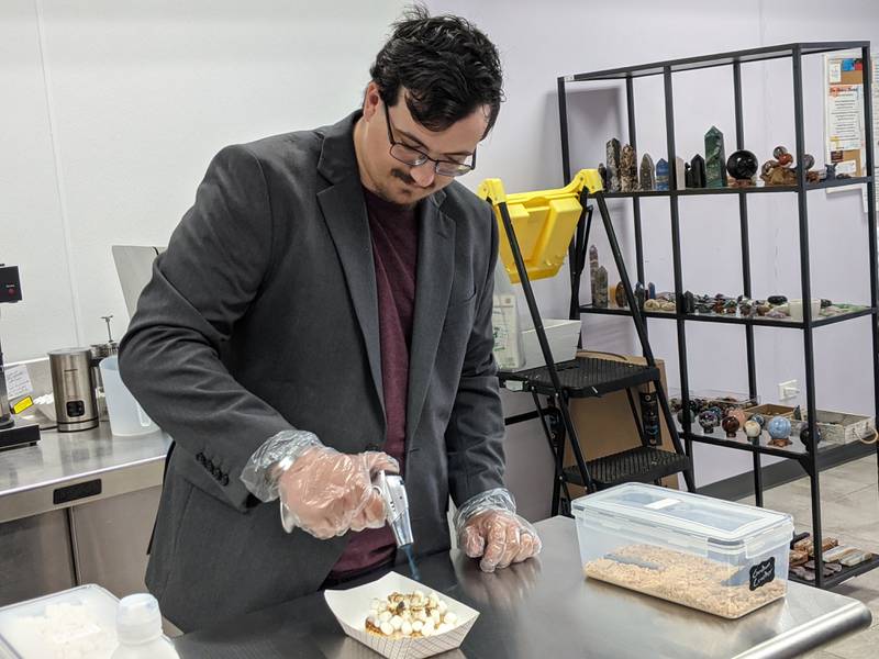 Josh Sommerville, owner of Fireside Treats, prepares a grilled s’mores donut, the most popular treat he sells at The Makers Cafe and Markets in Oswego.