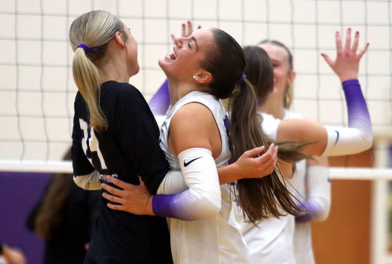 Hampshire’s Peyton Wurtz, left, Kylie Lambert and the Whip-Purs celebrate a point in their two-set win over Huntley in varsity girls volleyball at Hampshire High School in Hampshire on Tuesday, Sept. 23, 2025.