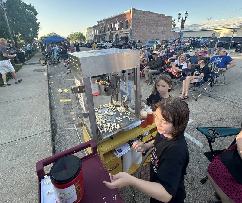 Emmie and Lily Nicholson, ages 9 and 7, of Mt. Morris were busy popping popcorn for the. Mt. Morris Senior & Community Center at the Mt. Morris Jamboree music concert on Friday, June 20, 2025. The free evening concerts are held on Fridays through the summer on the Campus in downtown Mt. Morris.