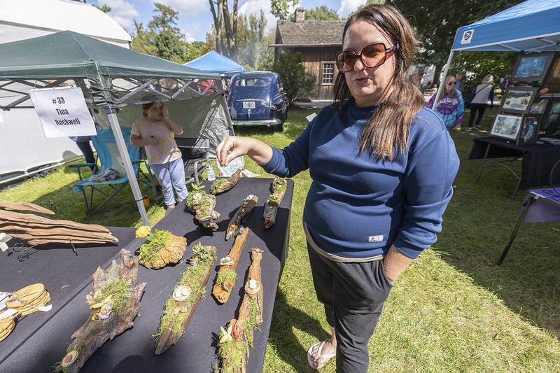 Tina Rockwell of Dixon shows off her art Sunday, Sept. 7, 2025, at the Grand Detour Arts Festival. Rockwell takes Rock River driftwood and adds moss, succulents and fantastic figures for unique art pieces.