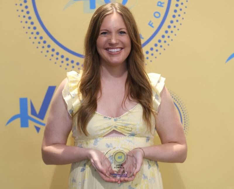 Julia Fowkes poses with her 40 Under Forty award during the Illinois Valley Chamber of Commerce Champions of Change Awards Night on Wednesday, May 6, 2026 at the Westclox Event Center in Peru.