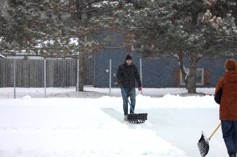 Sugar Grove Park District employee Chris Nesterowicz clears snow from the ice rink on Friday, Jan. 10, 2025 behind the Sugar Grove Township Community Building. The rink, which is possible through a partnership between the Sugar Grove Park District, Sugar Grove Township Sugar Grove Fire Protection District and Village of Sugar Grove,  is frozen and ready for skaters.