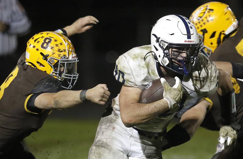 Cary-Grove's Logan Abrams   runs away from Jacobs' Brandon Chvatal (left) during a Fox Valley Conference football game on Friday, Oct. 24, 2025, at Jacobs High School in Algonquin.