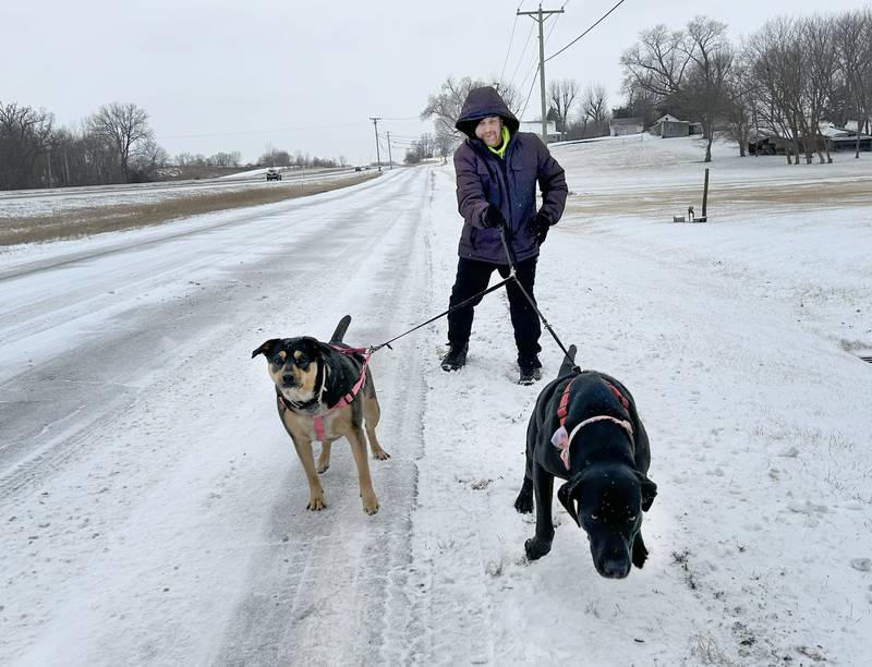 Ray Green and his dogs, Bob and Marley, didn't let a little snow stop them from taking their daily walk on North Frontage Road between Dixon and Sterling on Wednesday, Feb. 12, 2025.