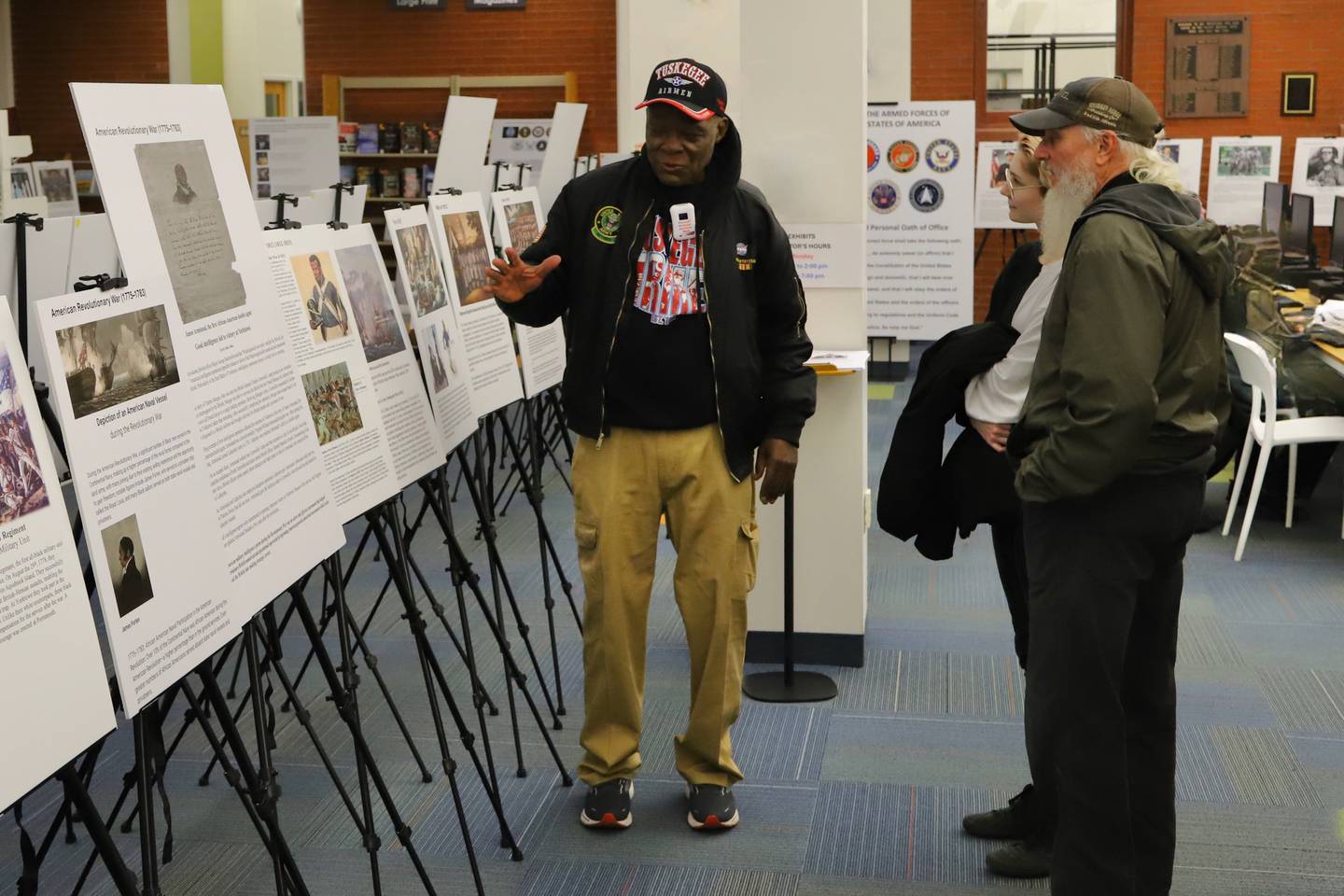 DeKalb resident Daniel "Doc" Habeel helps guide visitors through a photo exhibit he's curated for people to check out at the Sycamore Public Library in this undated photo.