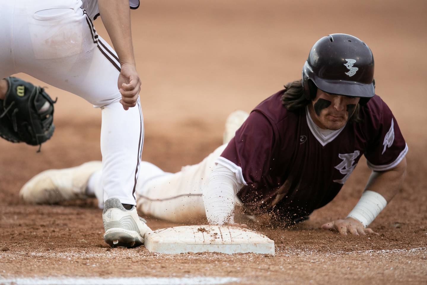 Richmond-Burton’s Brock Wood slides back to first on an attempted pick off against Joliet Catholic in the IHSA Class 2A championship game. Saturday, June 4, 2022 in Peoria.