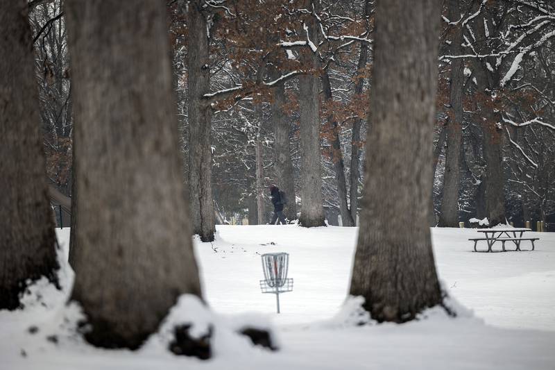 A hiker makes his way through the snowy trees in Sterling on Wednesday, Jan. 25, 2023.